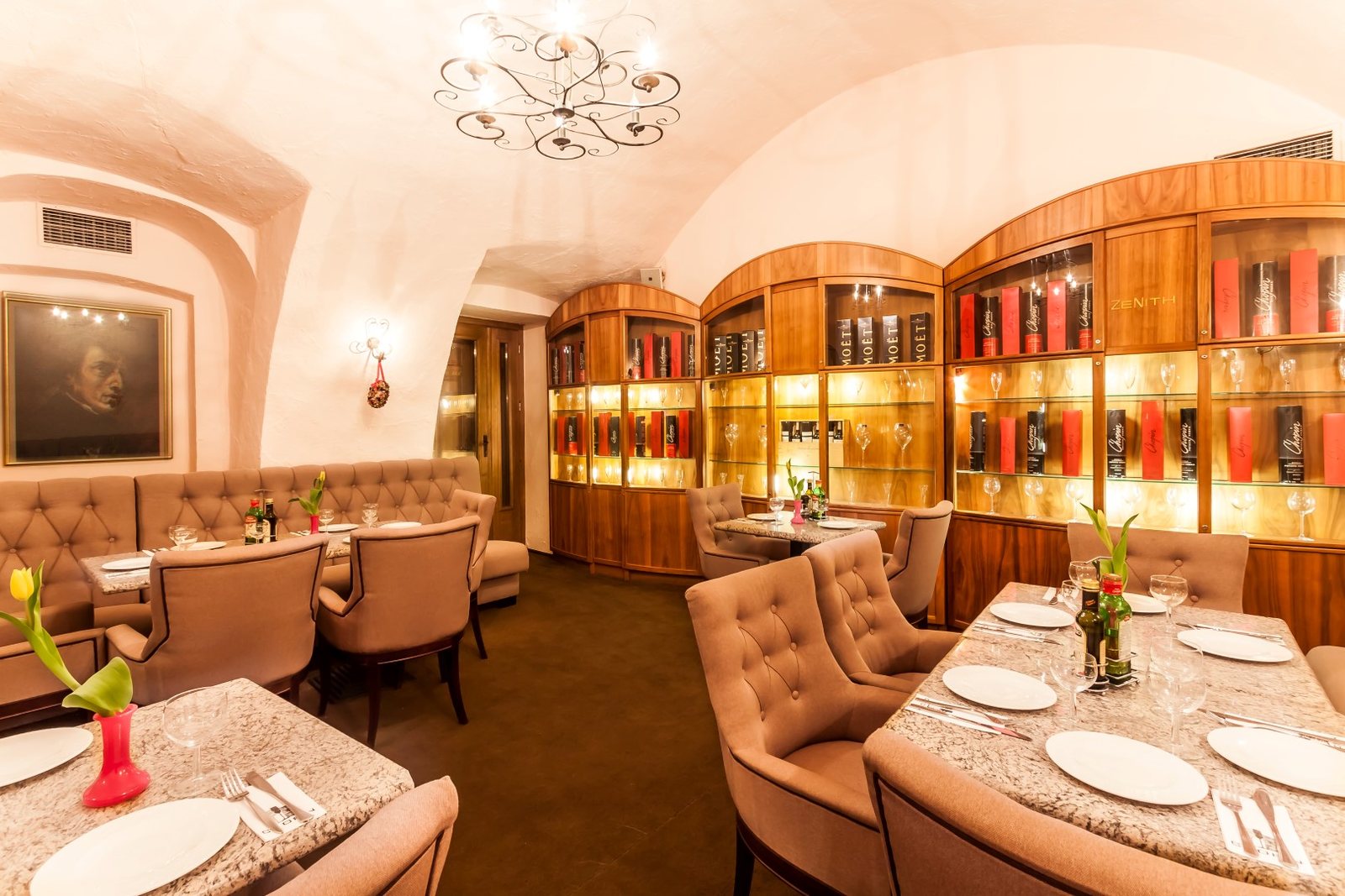 Chopin Ponad Czasem — elegant vaulted dining room with wine cabinet and Chopin portrait